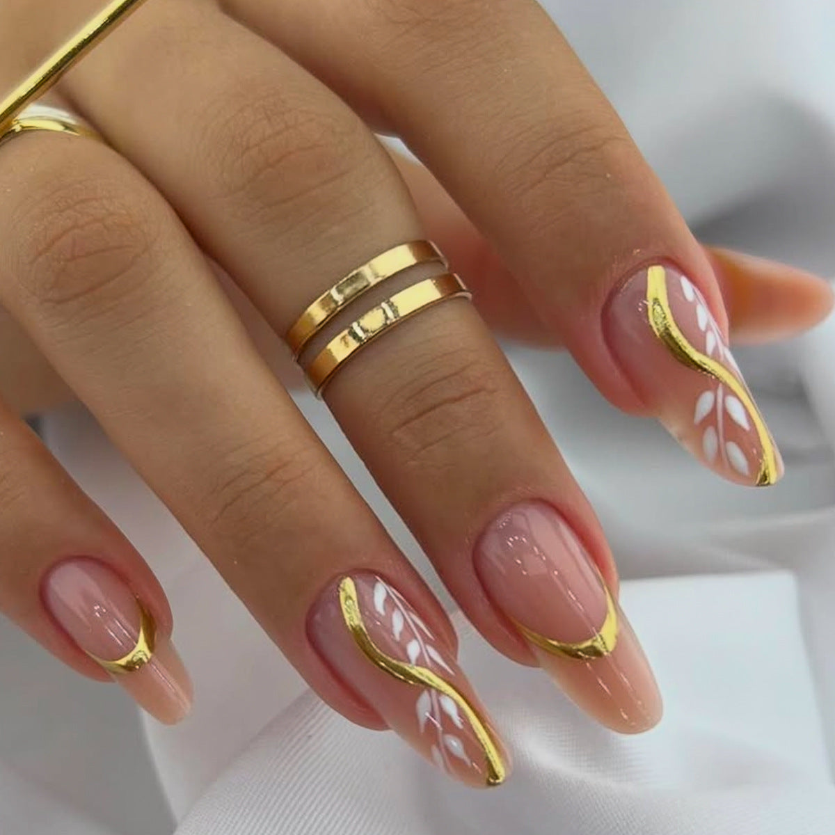 Enchanting Elegance Long Almond Pink Nails with Chic Gold Accents and Unique Floral Design