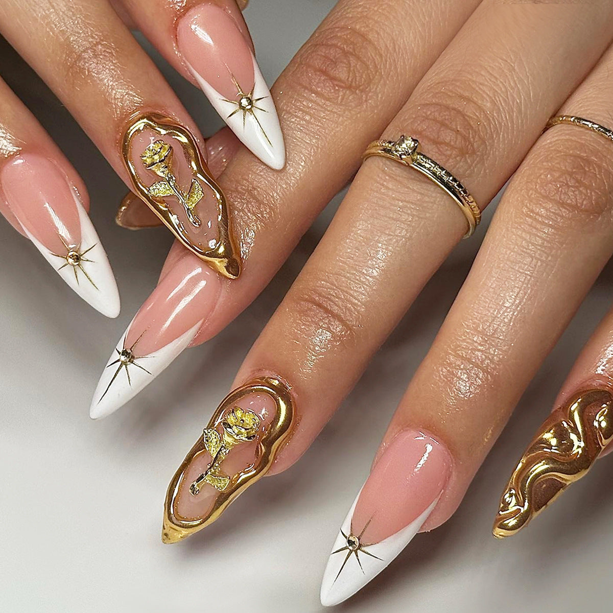 Elegant Floral Fantasy Long Stiletto Press On Nail Set in Soft Pink and Crisp White with Luxurious Gold Accents and Artistic Floral Design