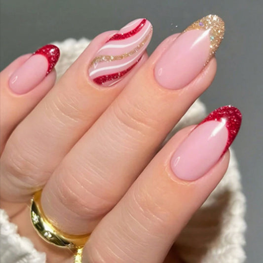 A close-up of a hand with medium-length oval nails adorned with pink, red, and gold glitter accents.