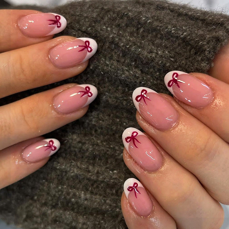 Chic Elegance Medium Oval Pink Nails with White Tips and Charming Burgundy Bow Details
