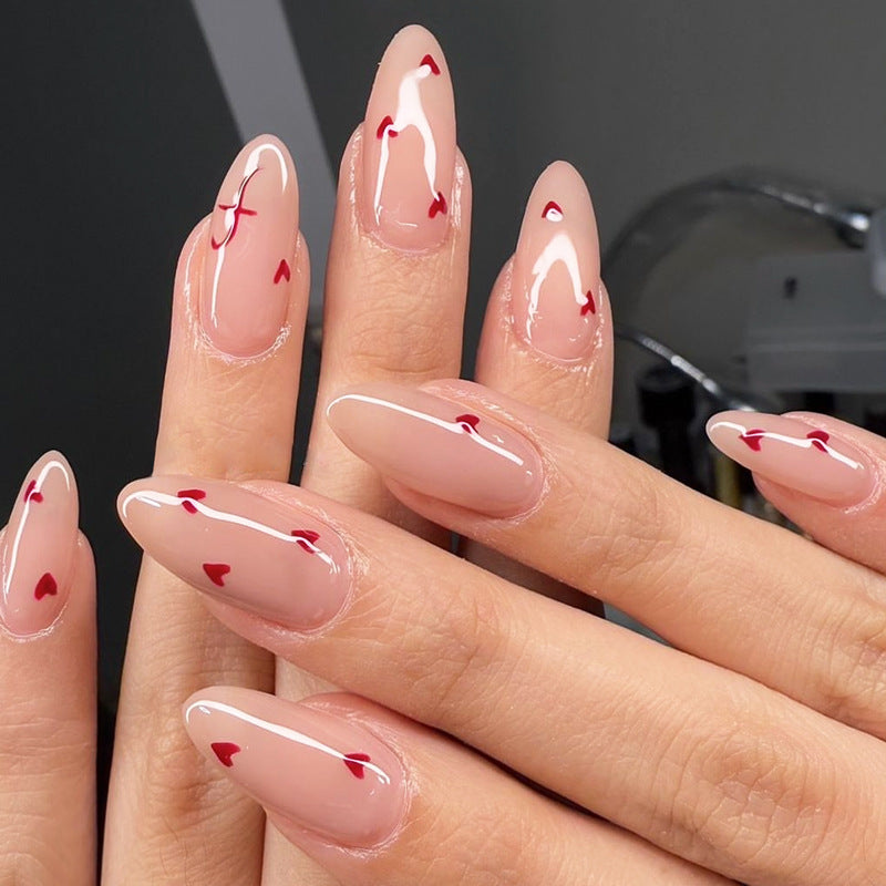 Charming Romance Long Almond Glossy Beige Nails with Heart Accents