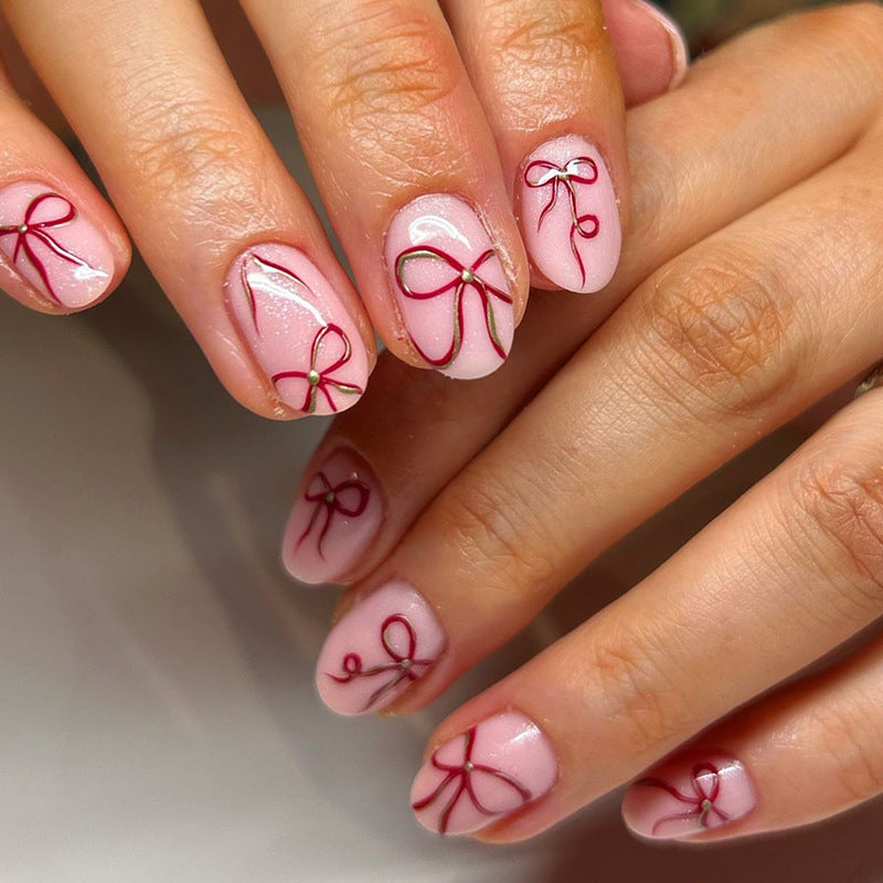 Charming Elegance Short Round Pink Nail Set with Delicate Bow Accents