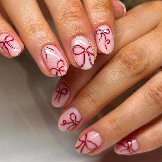 Charming Elegance Short Round Pink Nail Set with Delicate Bow Accents