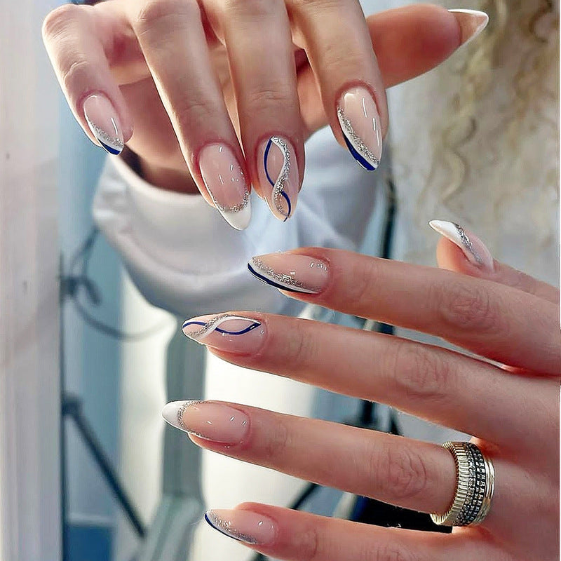 Close-up of hands with decorative nail art featuring blue and silver designs.