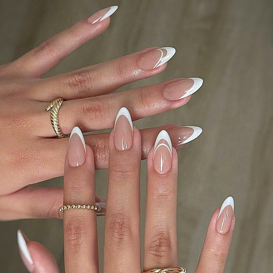 A set of long, clear, white press-on nails with a unique swirl design, displayed on a pair of hands.