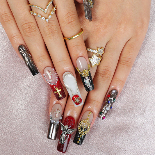 Close-up of hands with intricately designed nails and various rings on a light background