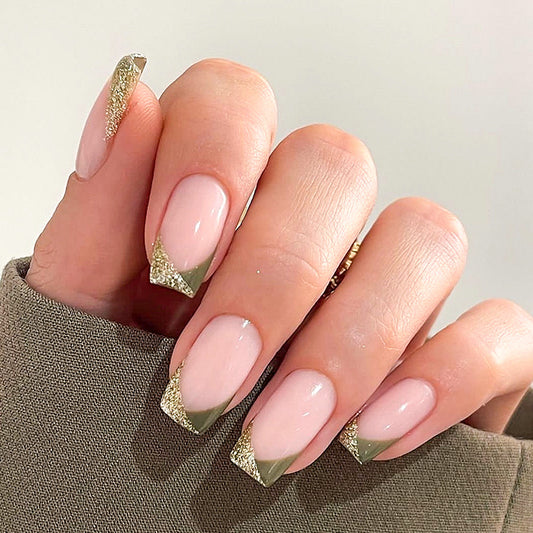 A set of press-on nails featuring square shapes, with beige and green coloring and glitter tips.