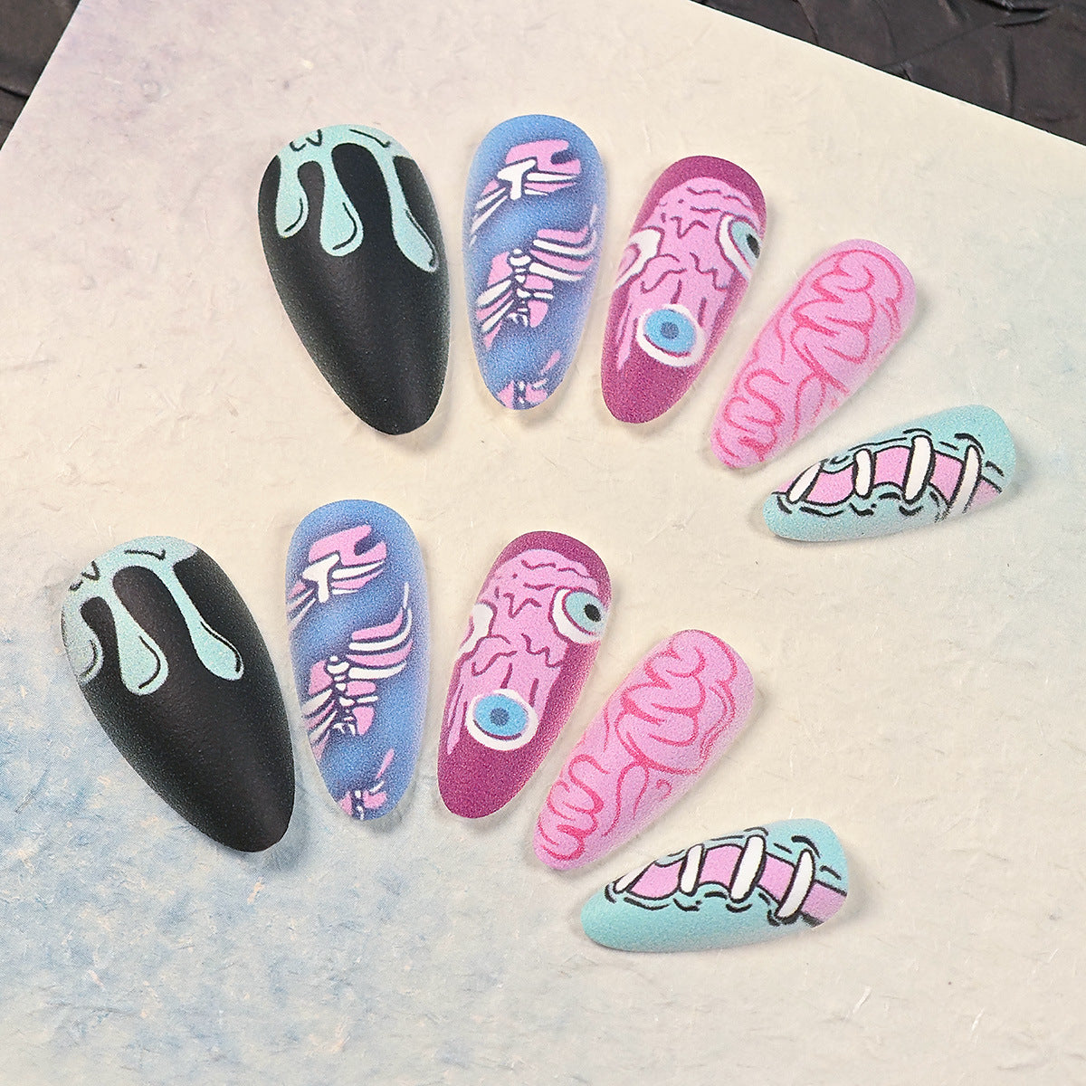 Eccentric Fantasy Long Almond Matte Black and Pastel Colorful Skeleton Nail Set with Unique Artistic Designs