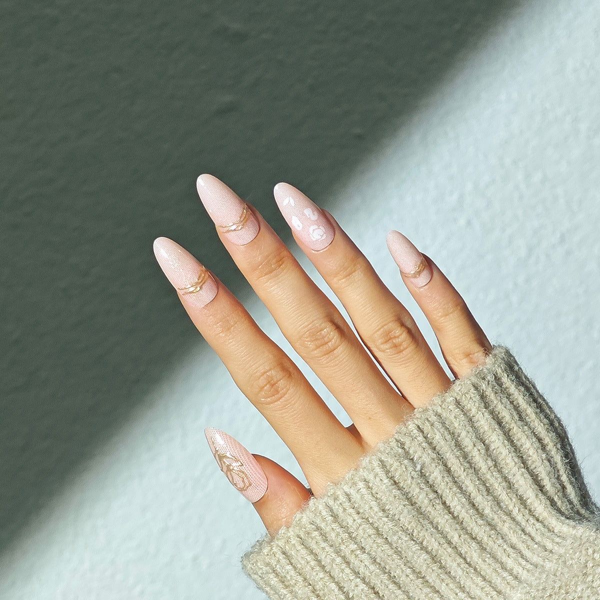 Whimsical Glamour Long Almond Pink Press On Nail Set with Golden Accents and Artistic Designs