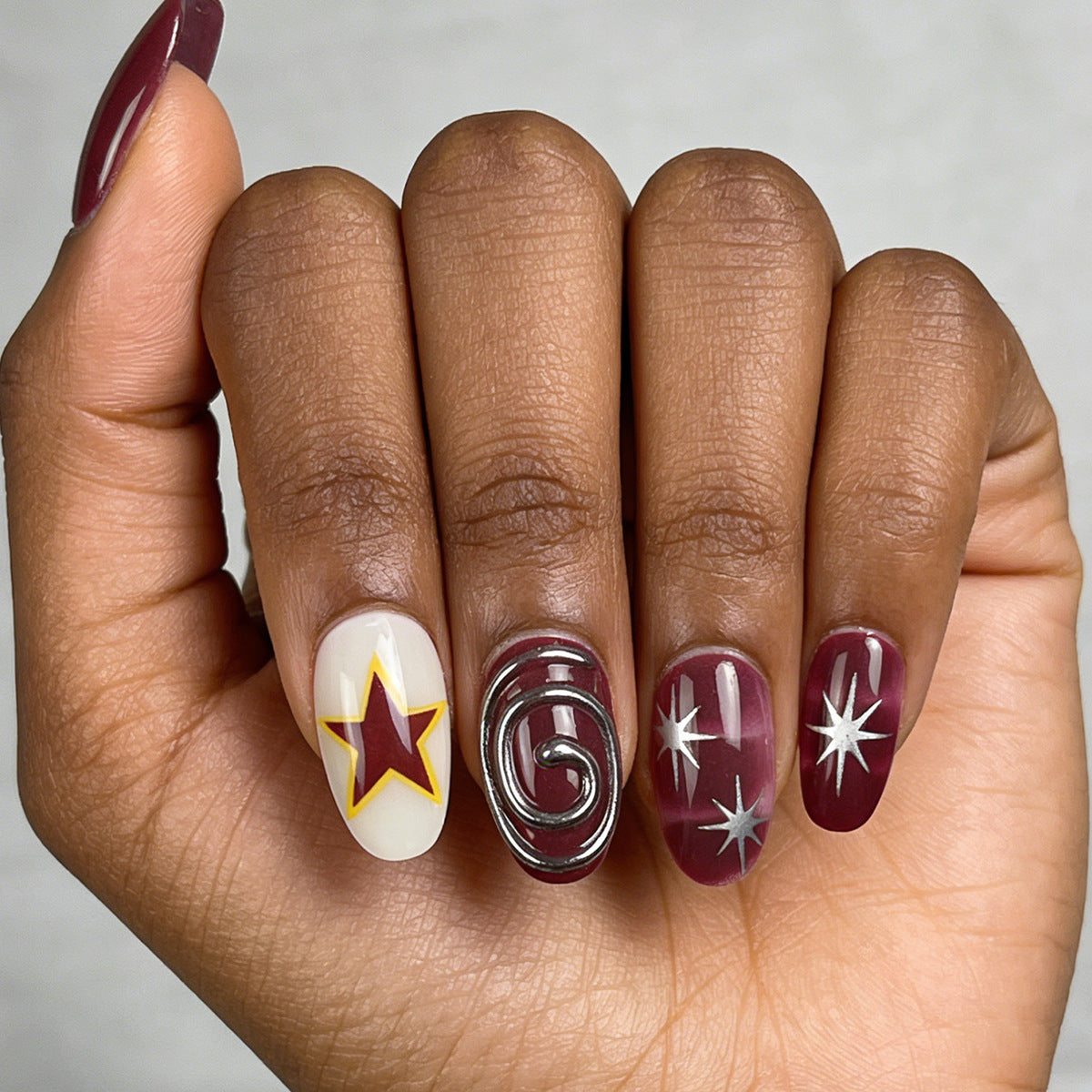 Cosmic Charm Medium Oval Burgundy with Unique Star and Swirl Design Press-On Nail Set