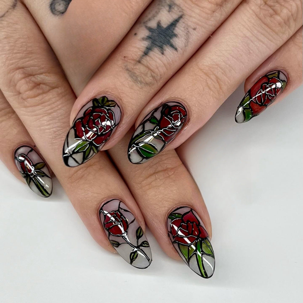 Nails with rose and vine design on a white background