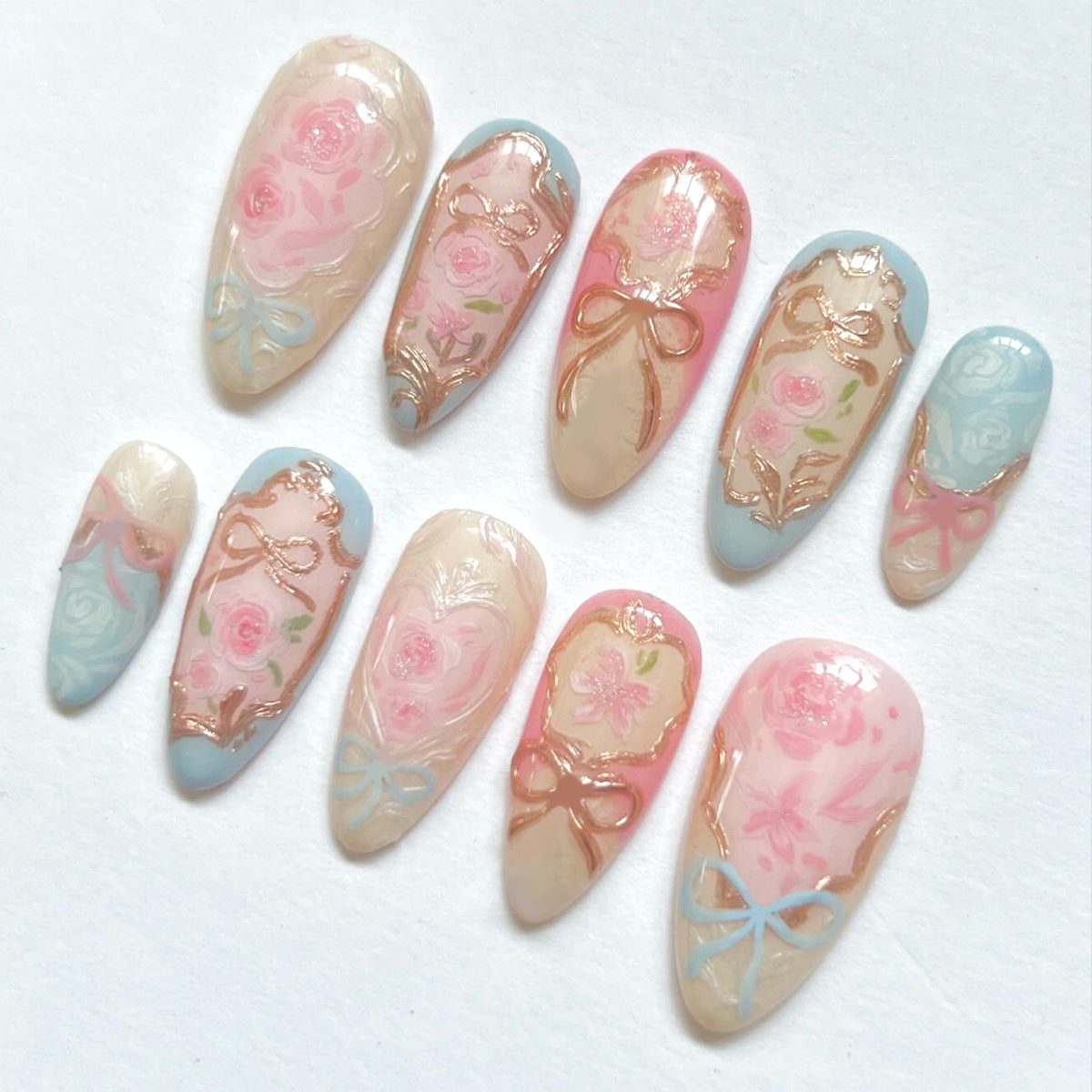 Whimsical Garden Inspired Medium Almond Pink Blue and Beige Floral Press-On Nail Set with Elegant Gold Accents