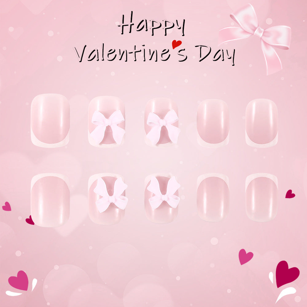 Valentine's Day-themed nail art set with bows and hearts on a pink background