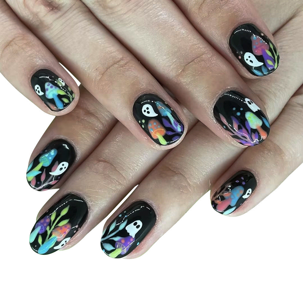 A set of press-on nails featuring a black base with a colorful mushroom and ghost design.