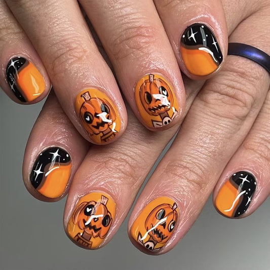 Halloween Pumpkin Charm Short Oval Orange and Black Press On Nail Set with Playful Skull Designs