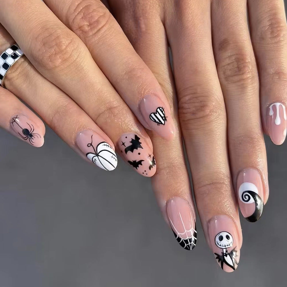 Nails with Halloween-themed designs on a neutral background