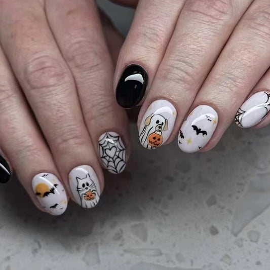 A set of medium oval black and white press on nail sets featuring playful dog and cat designs.