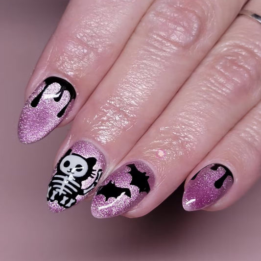 Spooky Glamorous Medium Almond Press-On Nail Set in Glittery Pink with Cute Skeleton and Bat Designs