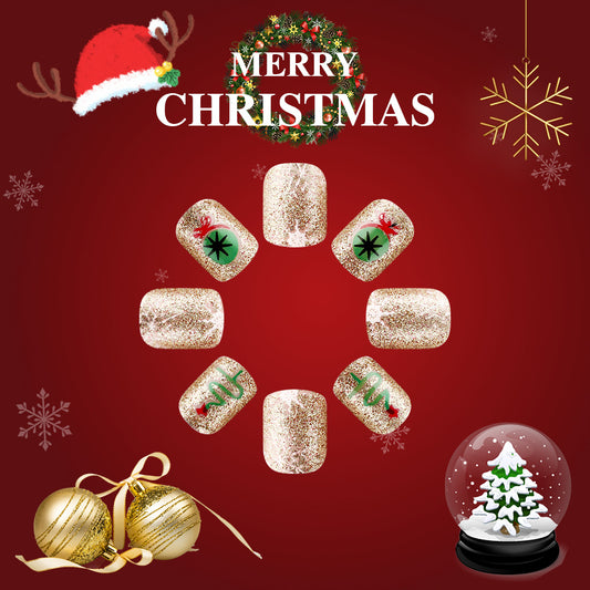 A set of press-on nails with a Christmas theme, featuring a glittery gold base and decorated with red, green, and white Christmas motifs such as snowflakes, ornaments, and a Christmas tree.