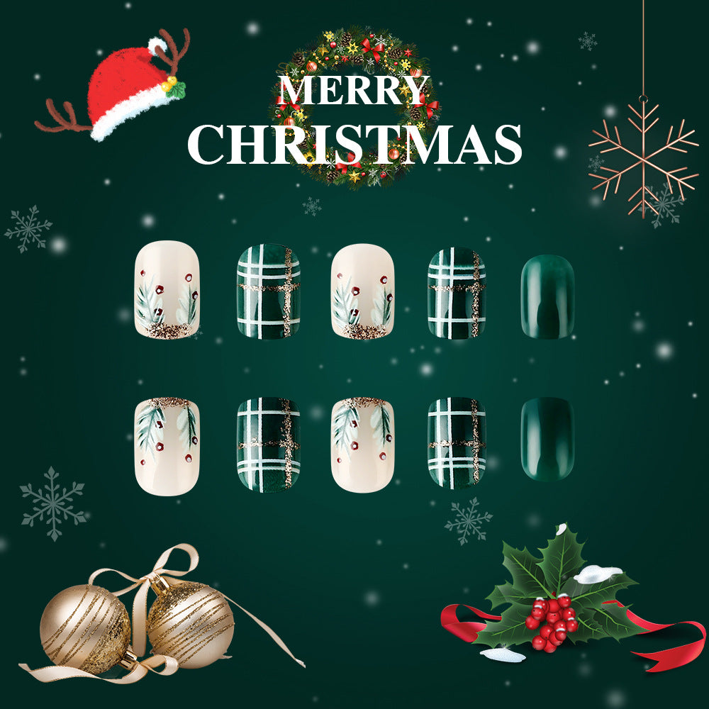 Christmas-themed nail art display with festive decorations on a green background.