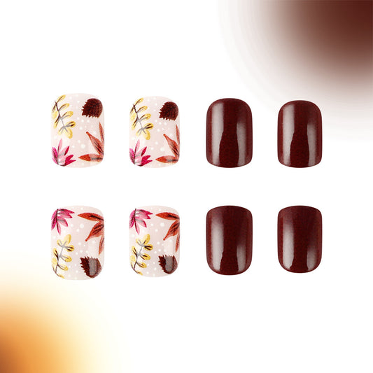A set of eight press-on nails featuring a floral pattern with burgundy and brown colors and unique glitter accents.