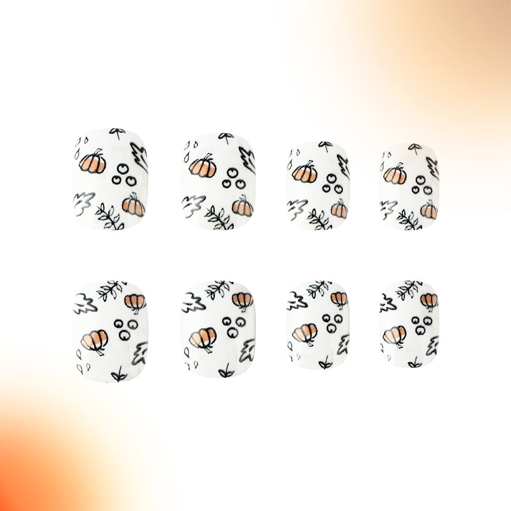 A set of press-on nails featuring a variety of designs including pumpkins, leaves, and abstract patterns in white, orange, and black colors.