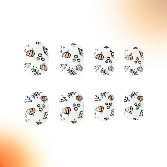 A set of press-on nails featuring a variety of designs including pumpkins, leaves, and abstract patterns in white, orange, and black colors.