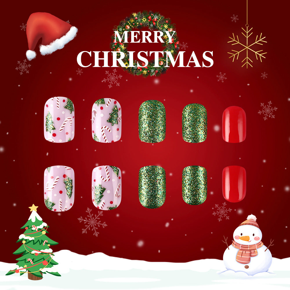 A set of press-on nails with a Christmas theme, including designs with red and green glitter, and holiday-related decorations like a Christmas tree and snowflakes.