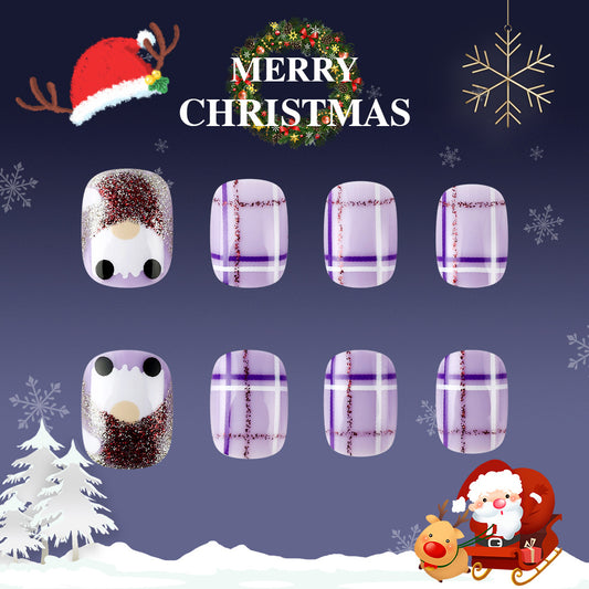 Set of Christmas-themed nail art designs with Santa Claus, reindeer, and snowflakes on a dark blue background.