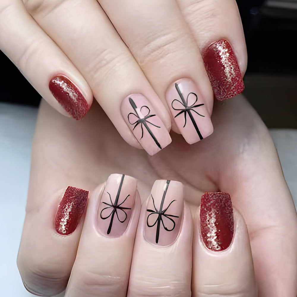 Gifted Elegance Press-On Nail Set Featuring Medium Square Blush Pink with Bow Design and Sparkling Red Accent