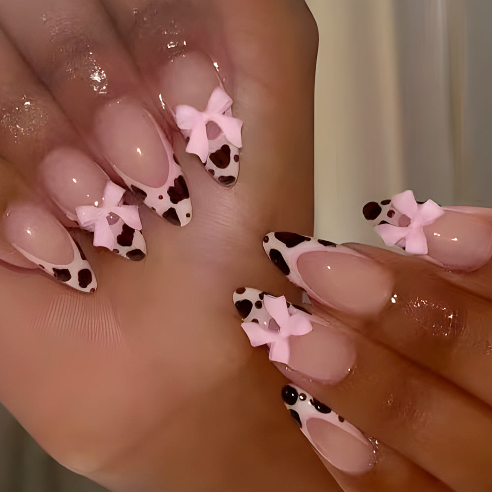 Charming Cowgirl Style Medium Almond Pink and Brown Splatter Nails with Cute Bow Accents