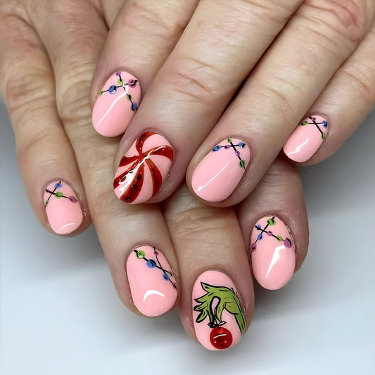 Festive Delight Short Oval Pink Press On Nail Set With Whimsical Holiday Designs