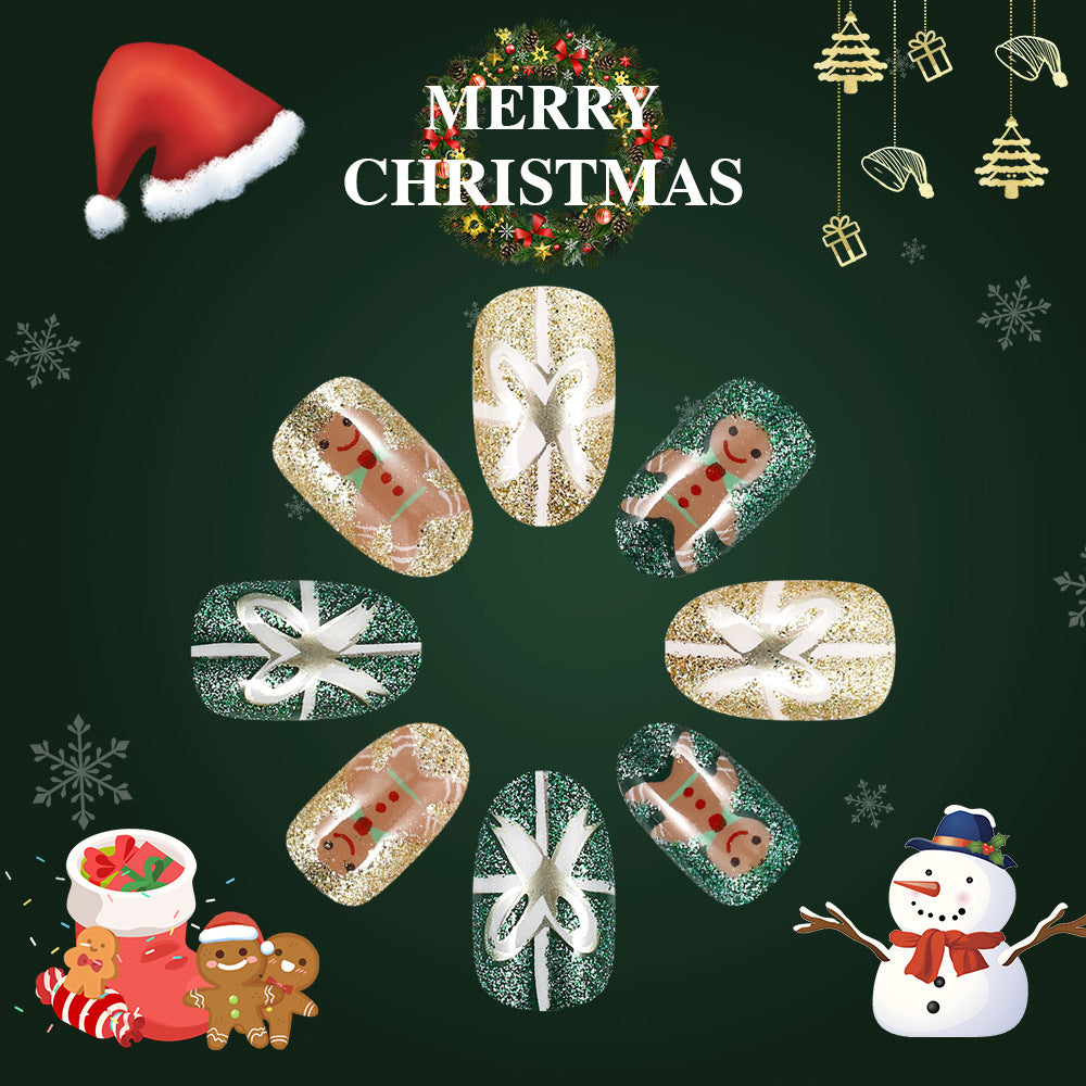 A set of round press-on nails with a Christmas theme, featuring a gingerbread man design in green and gold colors.