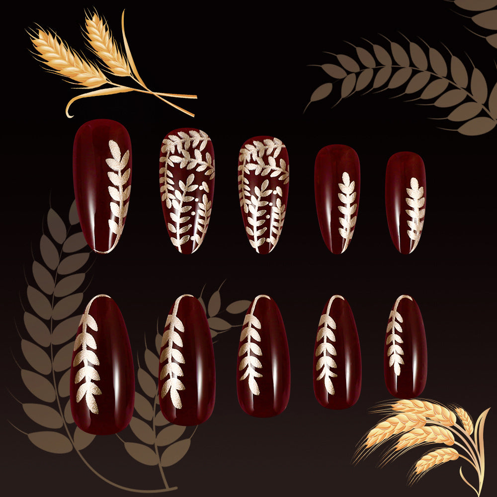 Harvest Elegance Lengthy Short Almond Burgundy Nail Set Featuring Intricate Gold Leaf Design
