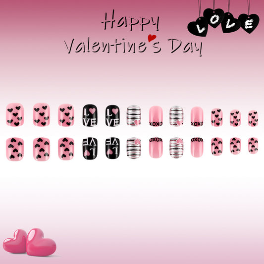 A collection of press on nails with a variety of designs including hearts and love messages to celebrate Valentine's Day, displayed in a gradient pink background.