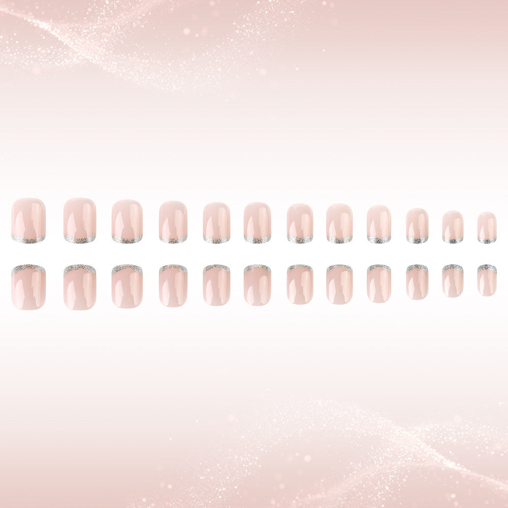 Row of pink nail polish strips on a light pink gradient background