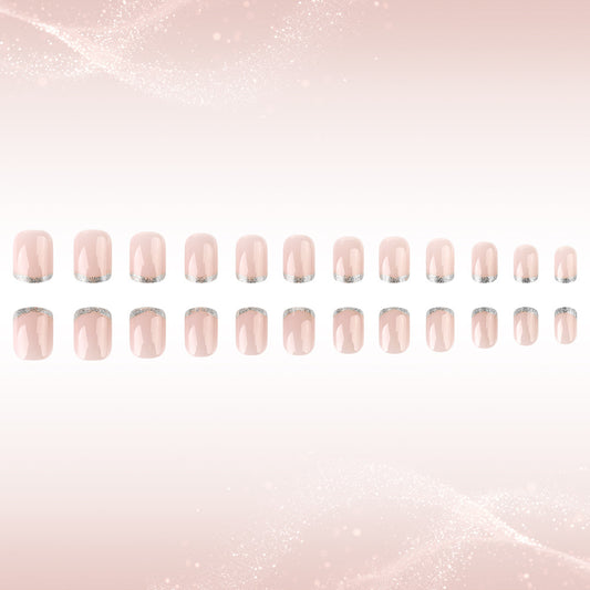 Row of pink nail polish strips on a light pink gradient background
