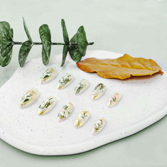 Enchanted Garden Long Almond White Nails with Floral Accents and Gold Tips