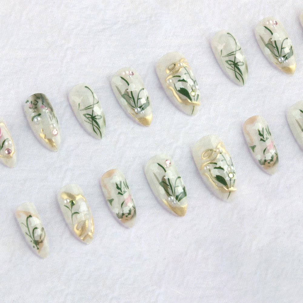 Botanical Elegance Press on Nail Set in Long Almond Shape Clear White with Delicate Floral Design and Gold Accents