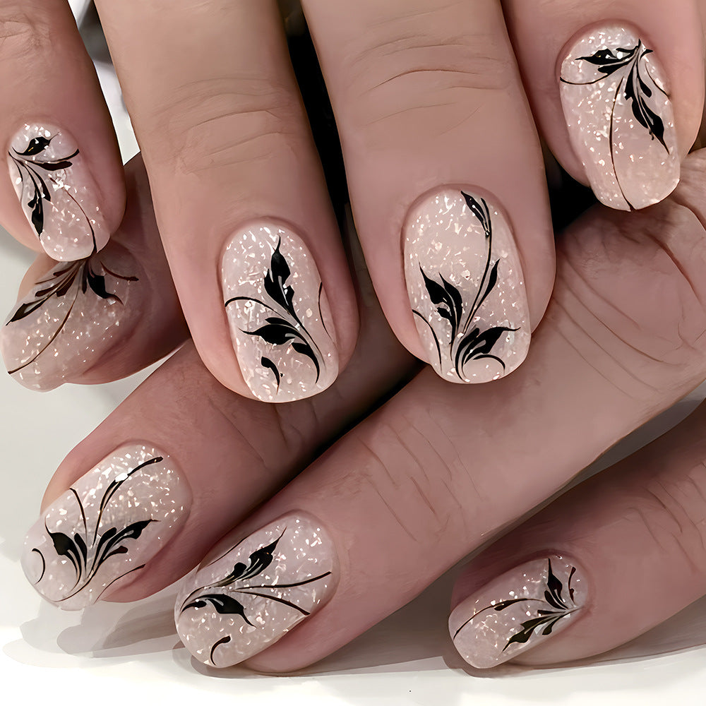 Enchanted Floral Press on Nails Medium Squoval Blush Pink with Sparkling Glitter and Elegant Black Artistry