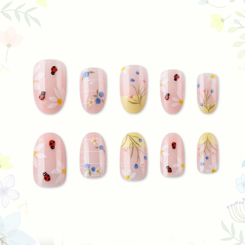 Whimsical Garden Medium Oval Pink Floral Press-On Nail Set with Charming Ladybug Accents
