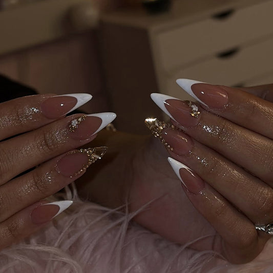 Close-up of hands with long, decorated nails on a blurred background