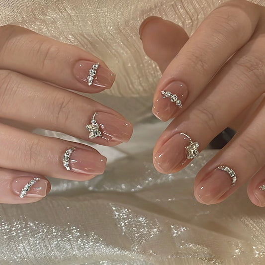 Close-up of hands with decorative nail art on a textured beige background