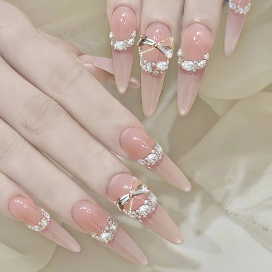 Elegant Charm Long Stiletto Peach Nails with Rhinestone Accents for a Glamorous Touch