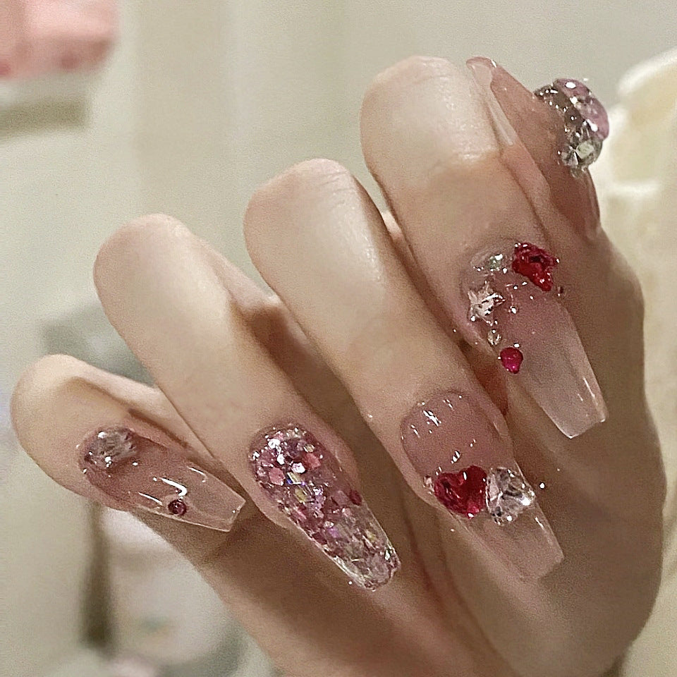 Nails with decorative gemstones on a neutral background