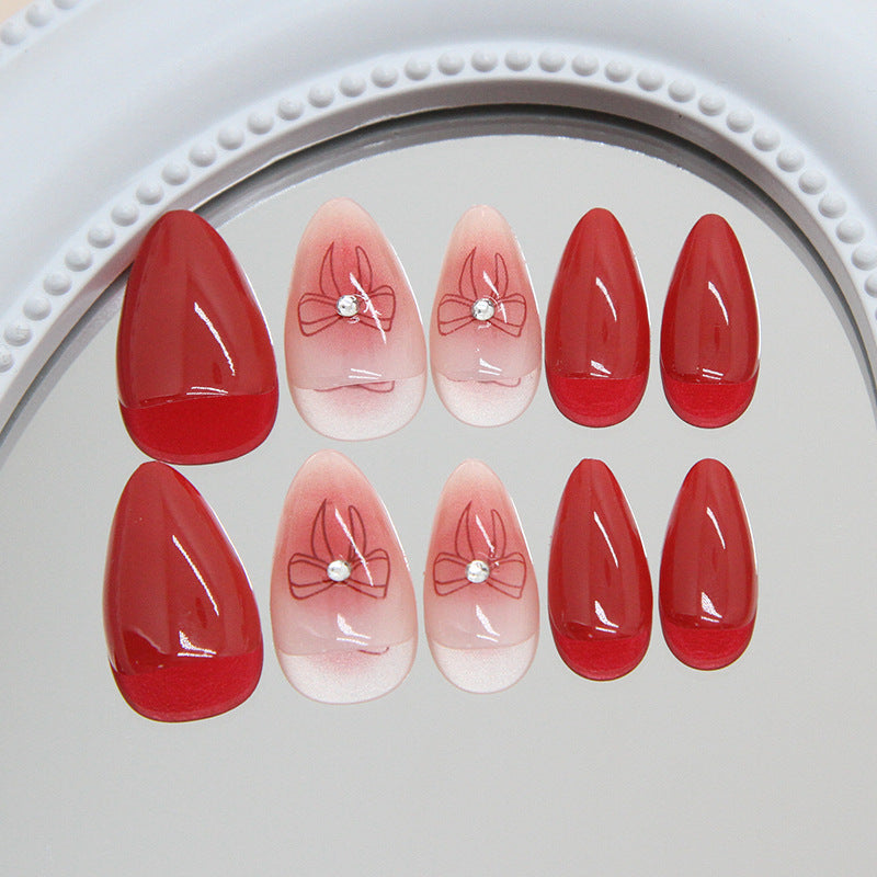 Charming Romance Red Short Almond Shape Press On Nail Set with Elegant Bow Design and Sparkling Gem Accent