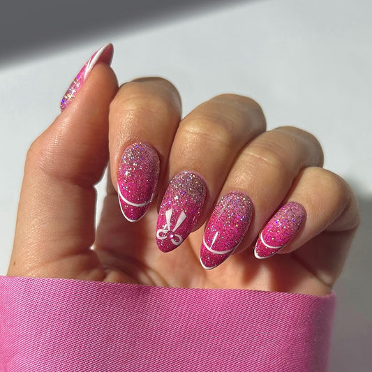 Chic Glamour in Short Almond Pink with Sparkling Glitter and Whimsical Nail Art