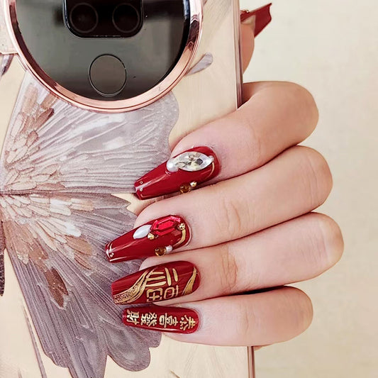 Glamorous Autumn Elegance Medium Coffin Red Nails with Stunning Gemstone Accents