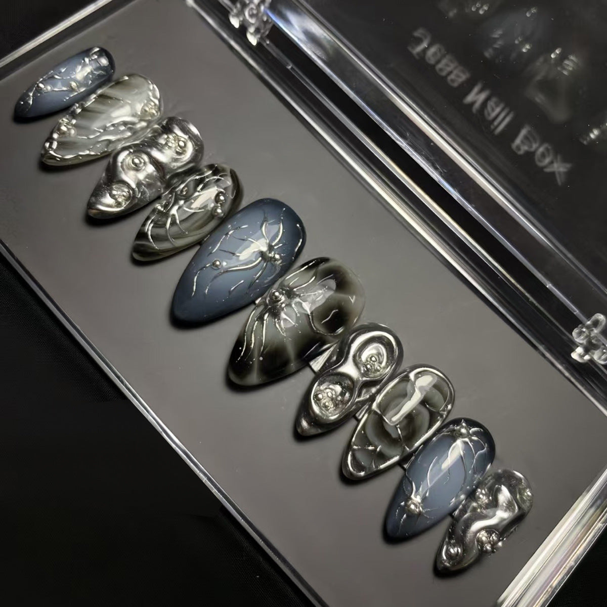 Haunting Elegance Short Almond Skull Shaped Dark Gray and Silver Press On Nail Set with Intricate Detailing