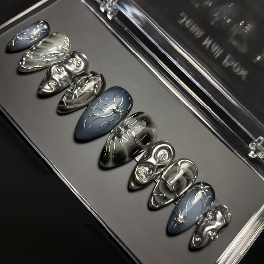 Haunting Elegance Short Almond Skull Shaped Dark Gray and Silver Press On Nail Set with Intricate Detailing